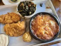  ?? Mary Ann Anderson/TNS ?? ■ Myrtle’s Chicken and Beer on Market Street in downtown Knoxville offer a decadent, very Southern, and super-cheesy tomato pie. Also find fried chicken, cheddar drop biscuits, and fried pimento cheese fritters in the lively restaurant.