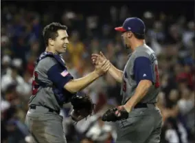  ?? CHRIS CARLSON — THE ASSOCIATED PRESS ?? United States’ Buster Posey and Luke Gregerson celebrate after the United States defeated Japan, 2-1, in a semifinal in the World Baseball Classic in Los Angeles, Tuesday.