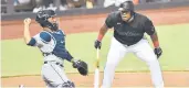  ?? CARDENAS/AP GASTON DE ?? The Marlins’Jesus Aguliar, right, reacts to a called ball during the first inning against the Rays on Friday in Miami.