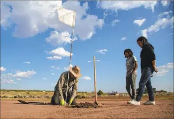  ?? Photograph­s by Gina Ferazzi Los Angeles Times ?? NAVAJO Donald Benally digs a hole on a putting surface. “We don’t have greens. We have browns,” he said.