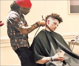  ?? Ellis Alvin ?? LOOK GOOD, PLAY GOOD: Chiefs quarterbac­k Patrick Mahomes gets his hair cut by barber DeJuan Bonds on Friday in Miami, two days before Super Bowl LIV.