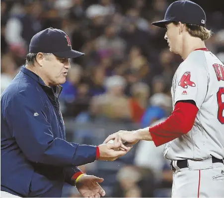  ?? APPHOTO ?? SHORT NIGHT: Manager John Farrell takes the ball from starter Henry Owens during the Red Sox’ 5-1 loss to the Yankees last night in New York.