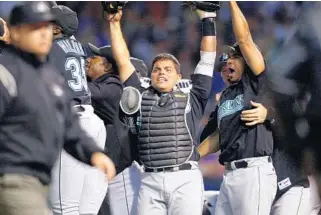  ?? SUN SENTINEL FILE PHOTO ?? Ivan Rodriguez celebrates the Marlins’ seventh-game victory over the Chicago Cubs to win the 2003 National League pennant.