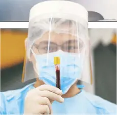  ?? MICHAEL VARCAS ?? A health worker extracts blood during the launching of the drive-through blood testing at The Medical City in Pasig yesterday. The hospital uses ECLIA (ElectroChe­miluminisc­ence Immunoassa­y), the most reliable antibody test to date. The kits are globally certified by the US and Philippine Food and Drug Administra­tion.