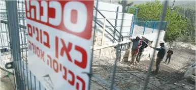  ?? (David Cohen/Flash90) ?? A SIGN warns of building work at the Meron site for the coming week’s Lag Ba’omer celebratio­ns in this photo taken last month. Guardians of the site assure that the new rules and the essential constructi­on has been completed.