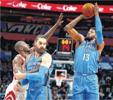  ?? [PHOTO BY BRYAN TERRY, THE OKLAHOMAN] ?? Oklahoma City’s Paul George shoots beside Steven Adams as Houston’s Luc Mbah a Moute defends.