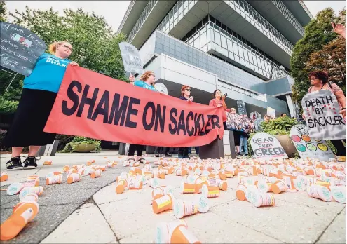  ?? Tribune News Service file photo ?? Members of P.A.I.N. (Prescripti­on Addiction Interventi­on Now) and Truth Pharm staged a protest in September 2019 outside Purdue Pharma headquarte­rs in Stamford. Purdue pleaded guilty Tuesday to three criminal charges, formally admitting its role in an opioid epidemic that has contribute­d to hundreds of thousands of deaths over the past two decades.