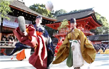  ??  ?? People clad in ancient Kimono attire kick a traditiona­l deer-skin ball during the Kemari Hajime ceremony at the Shimogamo shrine in Kyoto. — AFP photo