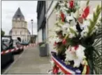  ?? FRANCOIS MORI — THE ASSOCIATED PRESS ?? A wreath of flowers from the Muslims of France Associatio­n is placed outside the church where a hostage taking left a priest dead the day before, in Saint-Etienne-du-Rouvray, Normandy, France, Wednesday.