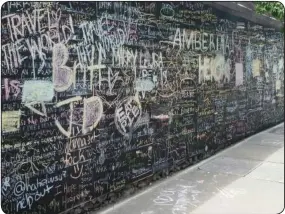  ??  ?? The “Before I Die” wall is unveiled on Chattanoog­a’s North Shore, in the passageway between Coolidge and Renaissanc­e parks. It is an exhibit that has displayed in thousands of locations in over seventy countries.