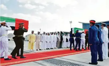  ?? WAM ?? The bodies of Emirati martyrs who were killed in a terrorist blast in Kandahar, Afghanista­n, while on a humanitari­an mission, arrived on board a military aircraft at Al Bateen airport yesterday and received official honours attended by senior...