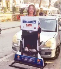  ??  ?? Life-sized cardboard cut-outs of people in wheelchair­s have been placed at disabled parking spaces in the walled city of the capital