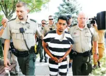  ?? AP PHOTO BY CHARLIE NEIBERGALL ?? Cristhian Bahena Rivera is escorted into the Poweshiek County Courthouse Wednesday for a court appearance in Montezuma, Iowa. Rivera is charged with first-degree murder in the death of Mollie Tibbetts.