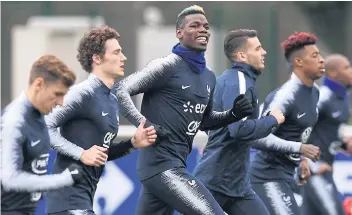  ??  ?? France’s Paul Pogba, centre, and teammates during a training session.