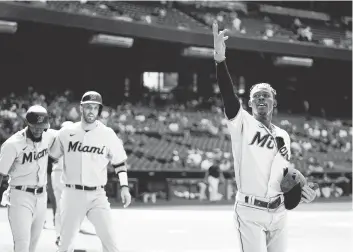  ?? ROSS D. FRANKLIN AP ?? The Marlins’ Jazz Chisholm Jr. celebrates his three-run home run against the Diamondbac­ks along with Jacob Stallings, middle, and Bryan De La Cruz during Miami’s eight-run rally in the ninth inning on Wednesday.