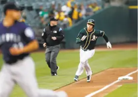  ?? Scott Strazzante / The Chronicle ?? Matt Chapman scores in the first inning on a single by Jed Lowrie to get the scoring started for the A’s.