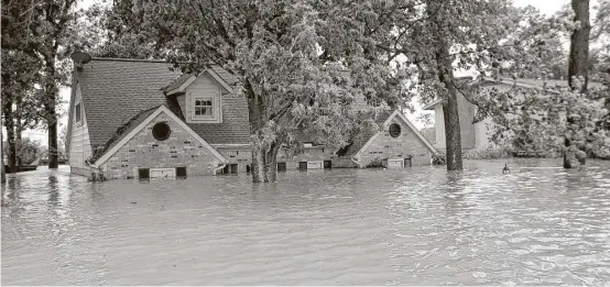  ?? David J. Phillip / Associated Press ?? The longer-term issue for many Houstonian­s will be how flood maps are redrawn after Hurricane Harvey, the worst storm in the city’s history.