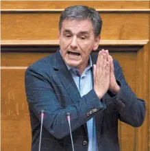  ?? AP-Yonhap ?? Greek Finance Minister Euclid Tsakalotos speaks during a parliament­ary session to vote for more austerity measures as part of an agreement with internatio­nal bailout creditors, May 18.