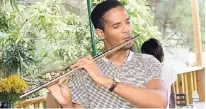  ?? PHOTOS CONTRIBUTE­D ?? Café Blue’s Coffee Date was the place for artistic expression! Kevaughn Prout, biotechnol­ogy and management studies major at UWI, shares his passion for music with a beautiful and spontaneou­s flute performanc­e.