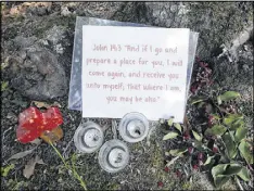 ?? ROGELIO V. SOLIS / ASSOCIATED PRESS ?? A verse of Scripture, a cross, three candles and some faded flowers lay on a tree root across from the Durant, Miss., home of Sister Margaret Held and Sister Paula Merrill, on Friday.