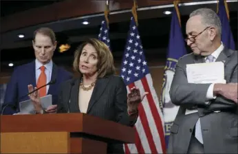  ?? AP PHOTO/J. SCOTT APPLEWHITE ?? In this Nov. 2 file photo, House Minority Leader Nancy Pelosi, D-Calif., flanked by Sen. Ron Wyden, D-Ore., the ranking member of the Senate Finance Committee, left, and Senate Minority Leader Chuck Schumer, D-N.Y., holds a news conference on Capitol...