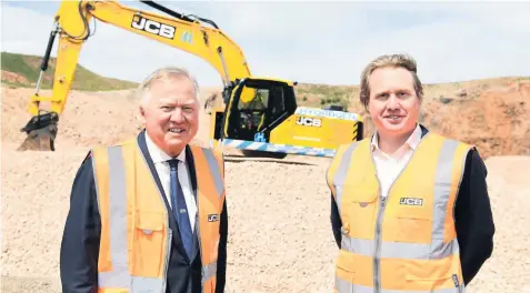  ??  ?? Lord Bamford and his son Jo pictured with the prototype 20-tonne JCB 220X excavator powered by a hydrogen fuel cell.