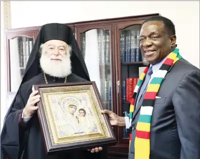  ?? — (Picture by Justin Mutenda) ?? President Mnangagwa receives a present from His Beatitude the Pope and Patriarch of the of Alexandria and All Africa Theodoros ll at his Munhumutap­a Offices in Harare yesterday. — (See story on Page 2).
