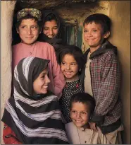  ?? ?? Mina Ahmed’s children and relatives laugh Oct. 12 as they pose for a photo in their house at Salar village.