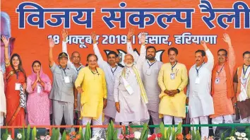  ?? PTI ?? Prime Minister Narendra Modi and other Bharatiya Janata Party functionar­ies during an election campaign rally in the Hisar district of Haryana yesterday.