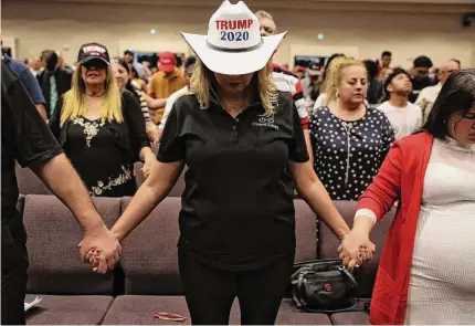  ?? Joe Raedle/Getty Images 2020 ?? People pray at an Evangelica­ls for Trump campaign event in Miami. COVID and Trump have fired up evangelica­l women.