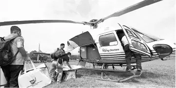  ??  ?? Election Commission employees moving electoral materials into a Sabah Air helicopter at the Penampang District Council field yesterday. The materials were flown to Sekolah Kebangsaan Long Kogulgan polling station for today’s polling. - Bernama photo