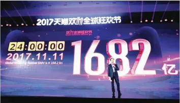  ?? — AFP ?? Alibaba CEO Daniel Zhang speaks in front of a screen showing total sales at over 168 billion yuan shortly after the end of the 11.11, or Singles’ Day shopping festival, at a gala event in Shanghai.