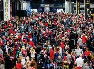  ?? PHIL SKINNER / AJC ?? Fans crowd Playoff Fan Central in the Georgia World Congress Center in downtown Atlanta on Sunday. The event was a 300,000-square-foot interactiv­e experience leading up to today’s game.