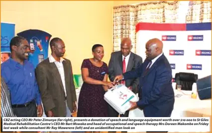  ??  ?? CBZ acting CEO Mr Peter Zimunya (far right), presents a donation of speech and language equipment worth over $10 000 to St Giles Medical Rehabilita­tion Centre’s CEO Mr Bart Mswaka and head of occupation­al and speech therapy Mrs Doreen Makombe on Friday...