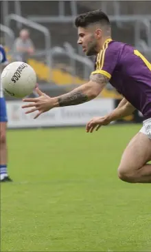  ??  ?? Wexford captain Paul Curtis attempts to break away from Monaghan