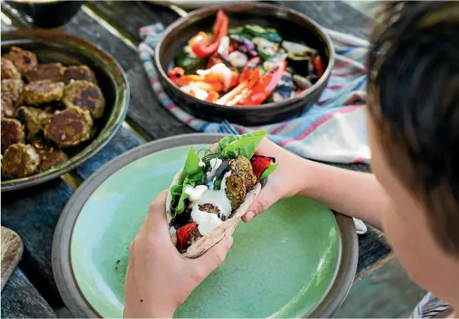  ?? PHOTOS: NICOLA GALLOWAY ?? These green pea and chickpea, and lamb, mint and oat rissoles are something the whole family will love, served with smoky, barbecued vegetables and yoghurt tahini sauce.