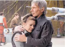  ?? SOURCE: LUCASFILM LTD. ?? Leia (Carrie Fisher), left, is comforted by Han Solo (Harrison Ford) during a scene from “Star Wars: The Force Awakens,” from 2015.