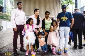  ??  ?? Refugees who helped Edward Snowden pose for a photo outside The Immigratio­n Tower in Hong Kong on Monday. (AFP)