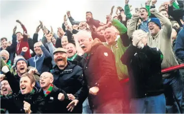  ??  ?? Stephen Beattie with his fellow Glentoran fans celebratin­g a win at the Oval several years ago