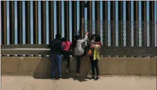  ?? SHUTTERSTO­CK ?? A group of women carrying their children attempt to cross the border in Juarez into the United States in April 2019.