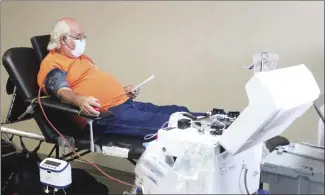  ?? Katie West • Times-Herald ?? Lewis Pugh reads over informatio­n about Power Red donations. Pugh was a Power Red donor at the American Red Cross blood drive at Forrest City Medical Center on Thursday. Power Red donors give two pints of blood instead of the normal one pint.