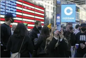  ?? RICHARD DREW — THE ASSOCIATED PRESS ?? Coinbase employees gather outside the Nasdaq Marketsite during the company’s IPO, in New York’s Times Square on Wednesday.