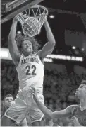  ??  ?? Arizona forward Zeke Nnaji dunks over USC defenders in the first half of their Pac-12 game at McKale Center on Thursday night in Tucson.
KELLY PRESNELL / ARIZONA DAILY STAR