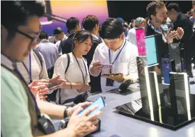  ??  ?? Top: Samsung’s Justin Denison speaks about the security features on the Note8. Above: Invited guests try out the new smartphone in New York.