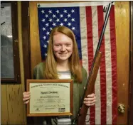  ?? CARLY STONE — MEDIANEWS GROUP ?? Rachel Champney with her Distinguis­hed Expert certificat­e and rifle she used to earn that title.