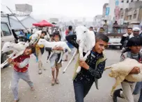  ?? Reuters ?? Boys carry goats at a livestock market in Sanaa on Saturday.