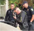  ??  ?? A police officer photograph­s a car outside the family home of Legan on Monday in Gilroy, Calif.