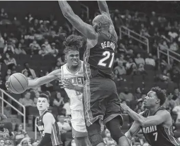  ?? Yi-Chin Lee / Staff photograph­er ?? Rockets guard Jalen Green scored 20 points in a preseason loss against the Heat while trying to get around the stifling defense from center Dewayne Dedmon. Green is averaging 12.3 points in the preseason.