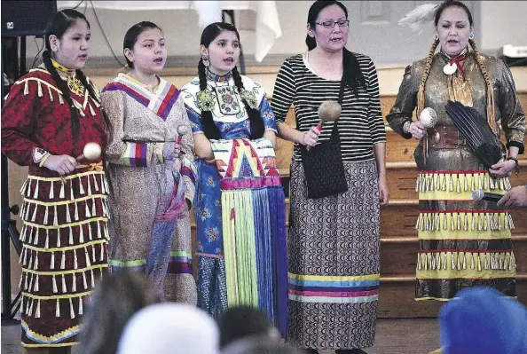  ?? PHOTOS: ED KAISER ?? Aboriginal dancers from the Bent Arrow Traditiona­l Healing Society perform Friday at a multicultu­ral welcome dinner for new Syrian refugees, which was organized by the Mennonite Centre for Newcomers at the Portuguese Canadian Hall in Edmonton.