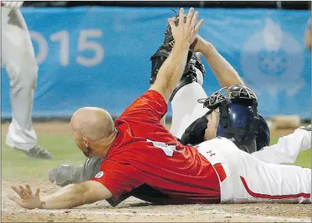  ?? — AP FILES ?? Canada’s Peter Orr slides safely into home under the tag of U.S. catcher Thomas Murphy to give Canada a 7-6 win in the 10th inning of the gold medal baseball game at the Pan Am Games in Ajax, Ont.